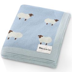 a blue blanket with sheeps on it and the name bleu lolo