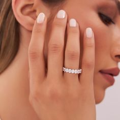 a woman's hand with a diamond ring on her finger