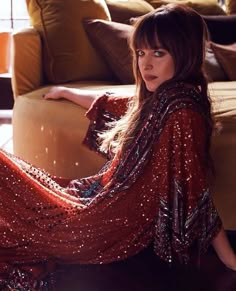 a woman sitting on top of a couch in a living room