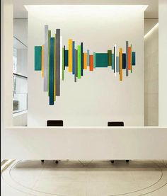 an abstract art piece is displayed on the wall in this modern office space with white walls and flooring