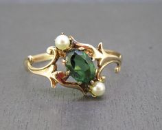 Gorgeous antique ring featuring a green tourmaline and tiny pearls.  Has a 10k gold setting, unmarked but tested and guaranteed 10k gold by me.  Light wear, no major issues. Size 6 3/4 Weighs approx. .8g Visit Ribbons Edge for more great pieces of vintage and antique jewelry!  All items added to your cart at Ribbons Edge will automatically combine shipping. To stay up to date with my newest offerings, follow me on IG @ RibbonsEdge Antique Pearl Rings, Signet Engagement Rings Women, Historical Jewellery Ancient Jewelry, Vintage Rings Antiques, Signet Engagement Rings, Green Engagement Ring, Pearl Engagement Rings, Gold Antique Engagement Rings, Art Nouveau Engagement Ring