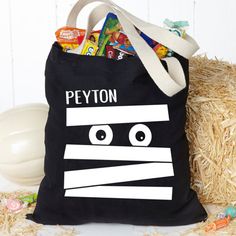 a tote bag with the words peyon printed on it next to some straw