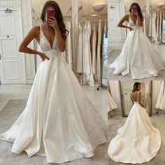 a woman taking a selfie while wearing a wedding dress in front of a mirror