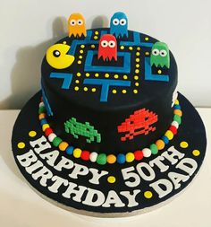 a birthday cake decorated with pacman and pac - man figures for a 50 year old