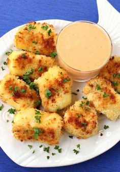 some food on a white plate with a dipping sauce