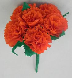 a bouquet of orange flowers sitting on top of a table