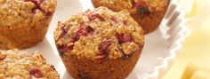 several muffins are sitting on a plate with strawberries in the middle and oatmeal topping