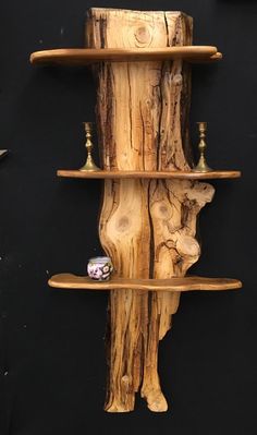 a shelf made out of wood with candles on it and some other items in the background