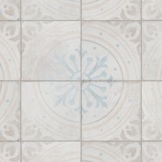 a white and gray tiled wall with an ornate design