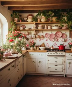 a kitchen filled with lots of pots and pans on the wall next to a stove top oven