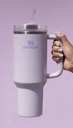 a woman's hand holding a tumbler cup