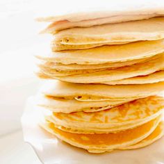 a stack of pancakes sitting on top of a white plate