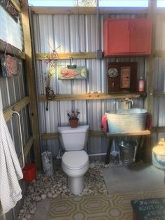 a bathroom with a toilet, sink and shelves