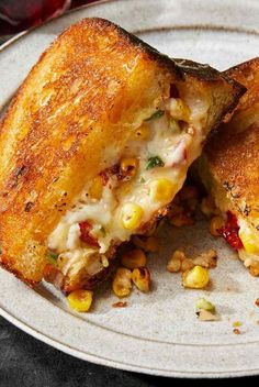 two grilled sandwiches on a plate with corn