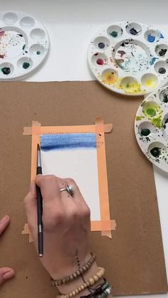 a person is doing something with paint and paper