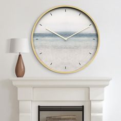 a living room with a fireplace and a large clock on the wall above it's mantle