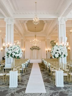 the aisle is lined with white flowers and gold chairs for an elegant wedding at the fairmont hotel