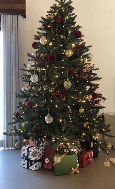 a christmas tree with presents under it