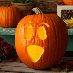 two pumpkins with faces carved into them