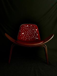 a red chair sitting on top of a black floor