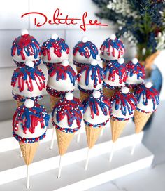 red, white and blue ice cream cones with sprinkles on them are displayed