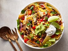 a bowl filled with taco salad and tortilla chips