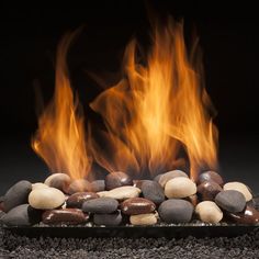 a fire burning in the middle of some rocks and stones on top of each other