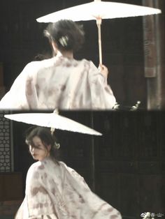 a woman in a kimono holding an umbrella