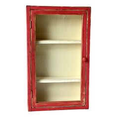 an old red cabinet with two shelves on the front and one shelf in the back