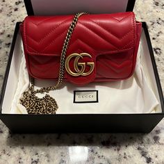 “Like New”Gg Marmont Leather Super Mini Bag Still Smells “ Brand New” Hibiscus Red Matelass Chevron Leather With Hibiscus Red Leather Detail Gold-Toned Hardware Attached Key Ring That Can Attach To A Separate Bag Double G Chain Shoulder Strap With 23.6" Drop This Item Can Fit A Cell Phone Up To 2.7”W X 5.8”H X .3”D The Gucci Card Case Wallet Will Fit Inside This Product Weight: .35kg Approximately Super Mini Size: 6.2"W X 4"H X 1.7"D Made In Italy Retail $1200 Asking $985 Comes W/ Original Box A Lights Winter, Hibiscus Red, Landscape Forest, Best Designer Bags, Chanel Backpack, Buy List, Ladies Bag, Replica Designer Handbags, Latest Bags