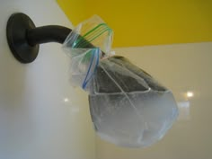 a plastic bag hanging from the side of a wall