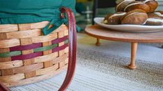 a basket filled with pastries sitting on top of a table next to a plate of donuts