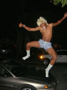 a shirtless man is jumping in the air