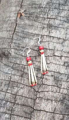 These earrings are handmade with natural porcupine quills.  They are strung on lightweight nymo thread, with red and beige tiny glass seed beads.   Each pair of these porcupine quill earrings are uniquely, and naturally elegant.  At the top of each of these porcupine quill earrings are red and light brown natural wood beads.   The porcupine quills in these earrings are each individually handwashed and trimmed to remove the sharp ends. These porcupine quill earrings measure (drop length - from th Porcupine Quill Jewelry, Quill Jewelry, Native American Jewellery, Porcupine Quills, Native American Beadwork, Native American Style, Southwest Art, Red Beads, Native American Fashion