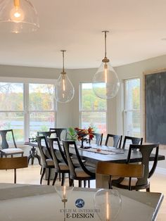 a large dining room table and chairs in front of windows