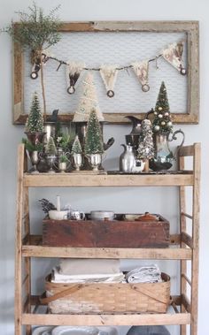 a wooden shelf filled with pots and pans on top of a white tablecloth