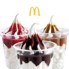 three desserts in plastic cups with toppings on top and mcdonald's logo above them