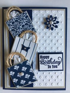 a close up of a birthday card on a white table with blue and white decorations