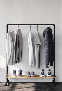 a rack with shoes and sweaters hanging on it