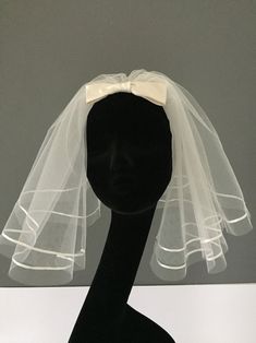 a mannequin head with a veil on it