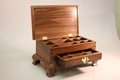 a wooden jewelry box sitting on top of a table