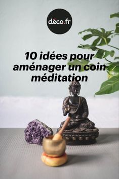 a buddha statue sitting on top of a wooden table next to a potted plant