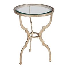 a glass top table with metal legs and a round glass top on an iron stand