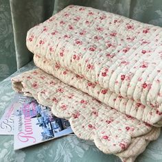 two bedspreads sitting next to each other on a bed