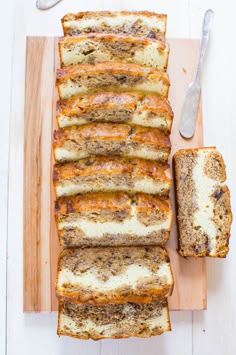 sliced loaf of bread sitting on top of a wooden cutting board