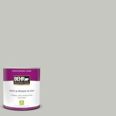 the behr paint is light beige with white trim and an open can on top