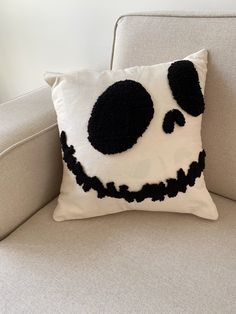 a white couch with a black and white pillow on it