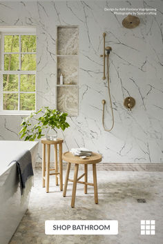 a bathroom with marble walls and flooring is featured in the magazine shop bath room