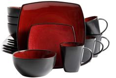 a red and black dinnerware set with matching cups