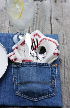 an image of a denim pocket with utensils and napkins in it on the table